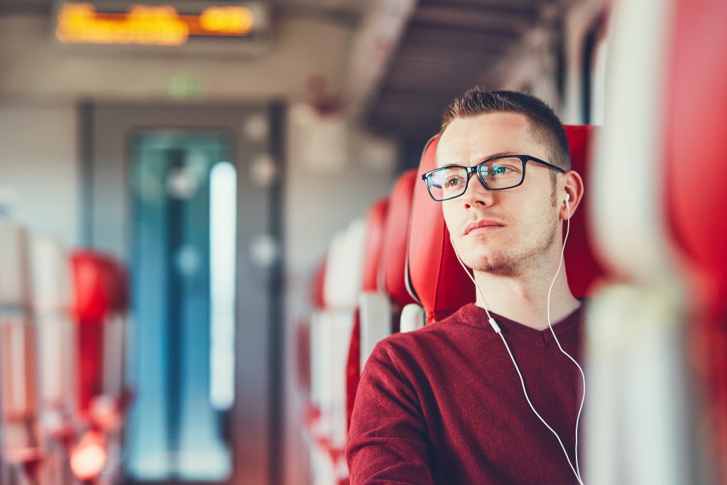 Young man traveling by train